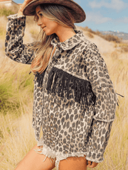 Leopard print denim jacket with collared neck, frayed details, and black fringe embellishment.