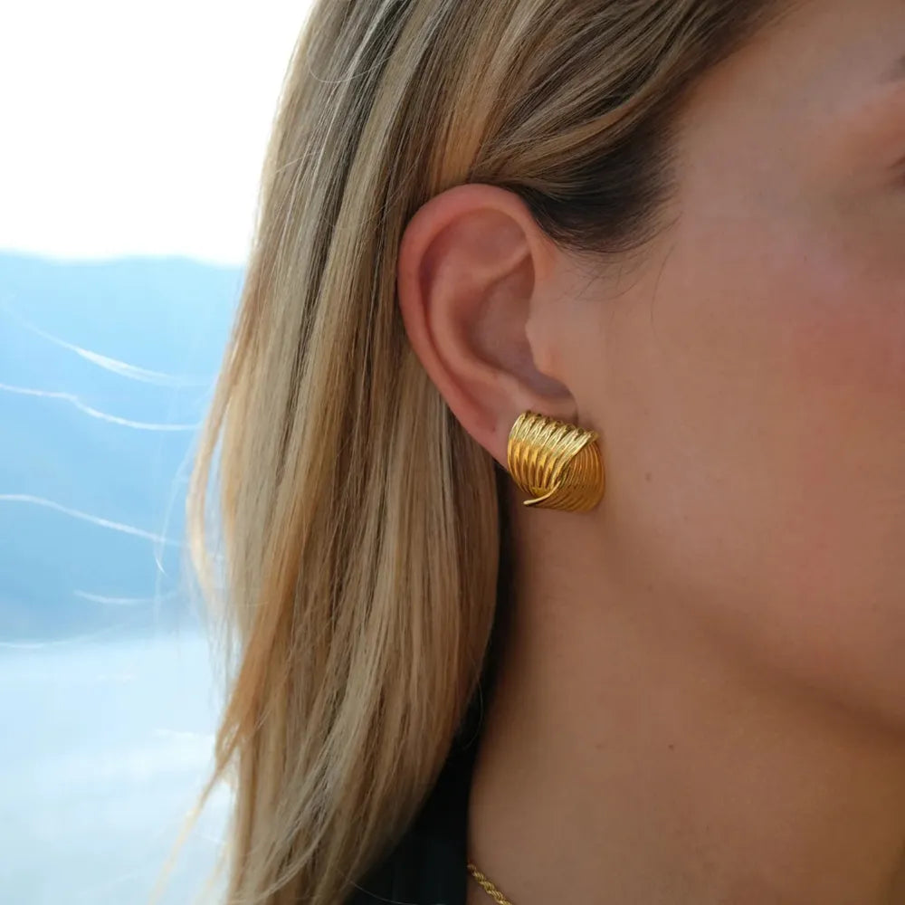 Gold coil earrings with a sculpted, layered design, 18K gold-plated.