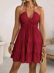 Red halter neck ruffled mini dress with tiered skirt and deep V-neck.