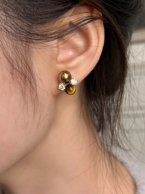 Spherical tiger eye stone stud earrings with clear accents and a cluster design.