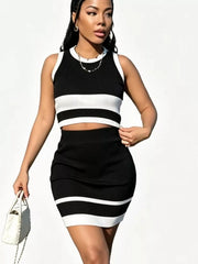 Black and white striped knit two-piece set with contrast trim, ribbed texture, and a sleeveless crop top and mini skirt.
