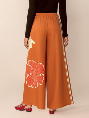 Tangerine floral palazzo trousers with side stripe detail and wide leg cut.