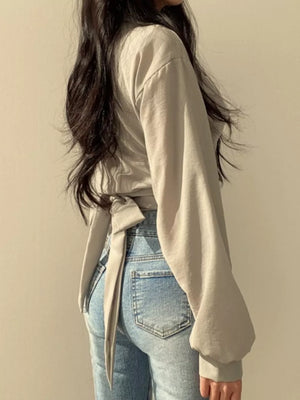 Grey polyester long sleeve maternity shirt with a twisted knot front detail and tie back.