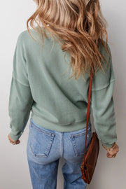 Relaxed sage waffle knit crewneck sweater with crew neckline and long sleeves.