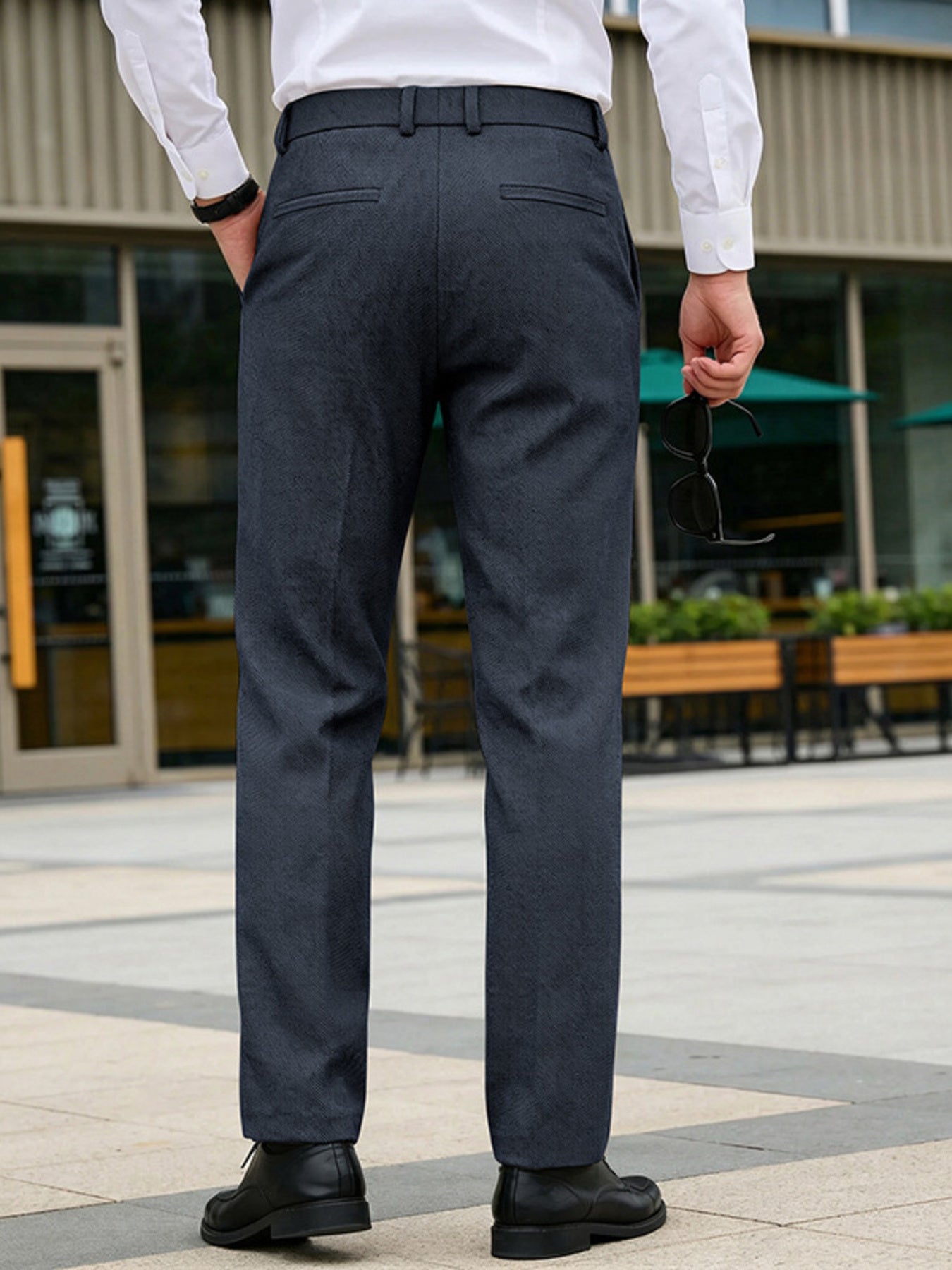 Classic fit men's dark gray dress pants with pockets and a subtle herringbone pattern.