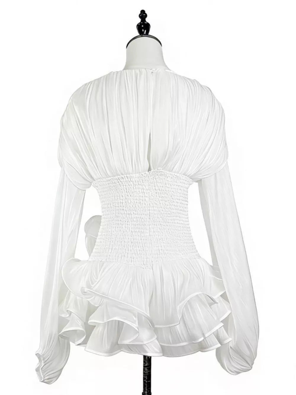 White cotton mini dress with ruched bodice, corset waist, and ruffled hem.