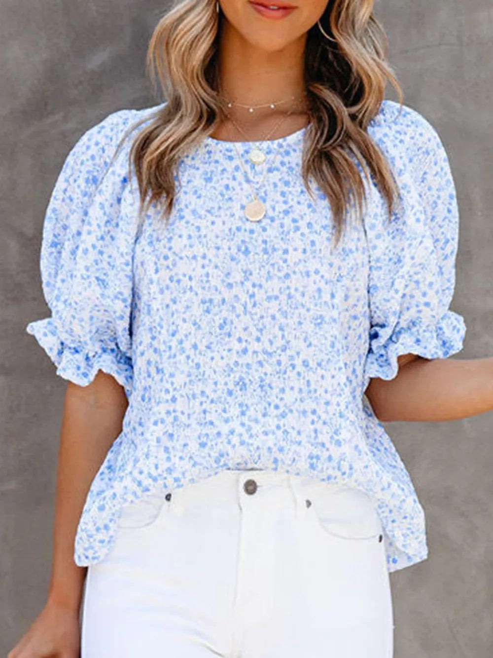 Sky blue floral print maternity blouse with ruffle sleeves and smocked bodice.
