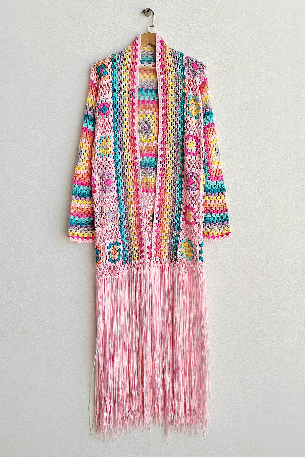 Crochet duster with granny squares, multicolor stripes, and pink fringe.