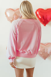 Blush pink off-shoulder sweatshirt with balloon sleeves and a relaxed fit.