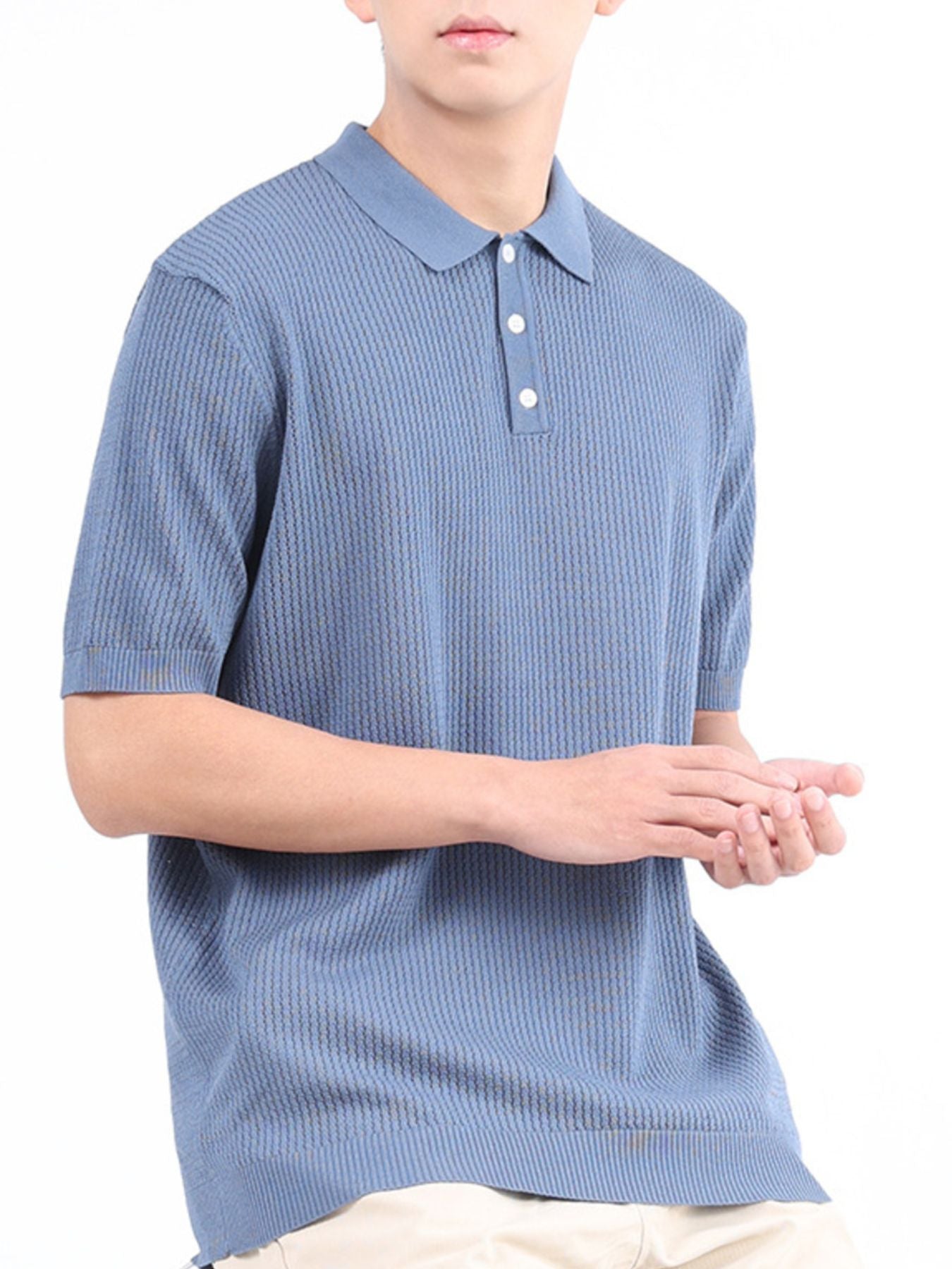 Light blue textured knit polo shirt with classic collar and short sleeves.