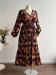 Maxi dress with floral print, V-neck, long sleeves, tiered skirt, and lace trim.
