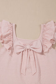 Blush pink textured blouse with ruffle sleeves and a large front bow detail.