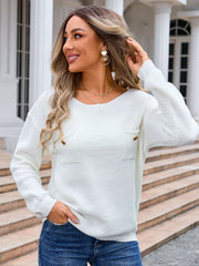 White textured knit sweater with button detail pockets and crew neck.