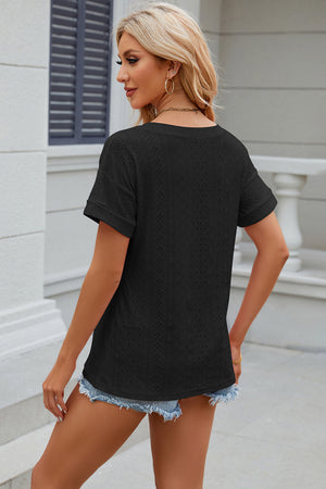 Black perforated tee with rolled sleeves and a casual fit.