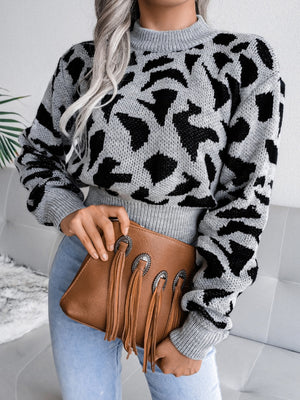 Gray abstract knit cropped sweater with mock neck and long sleeves.