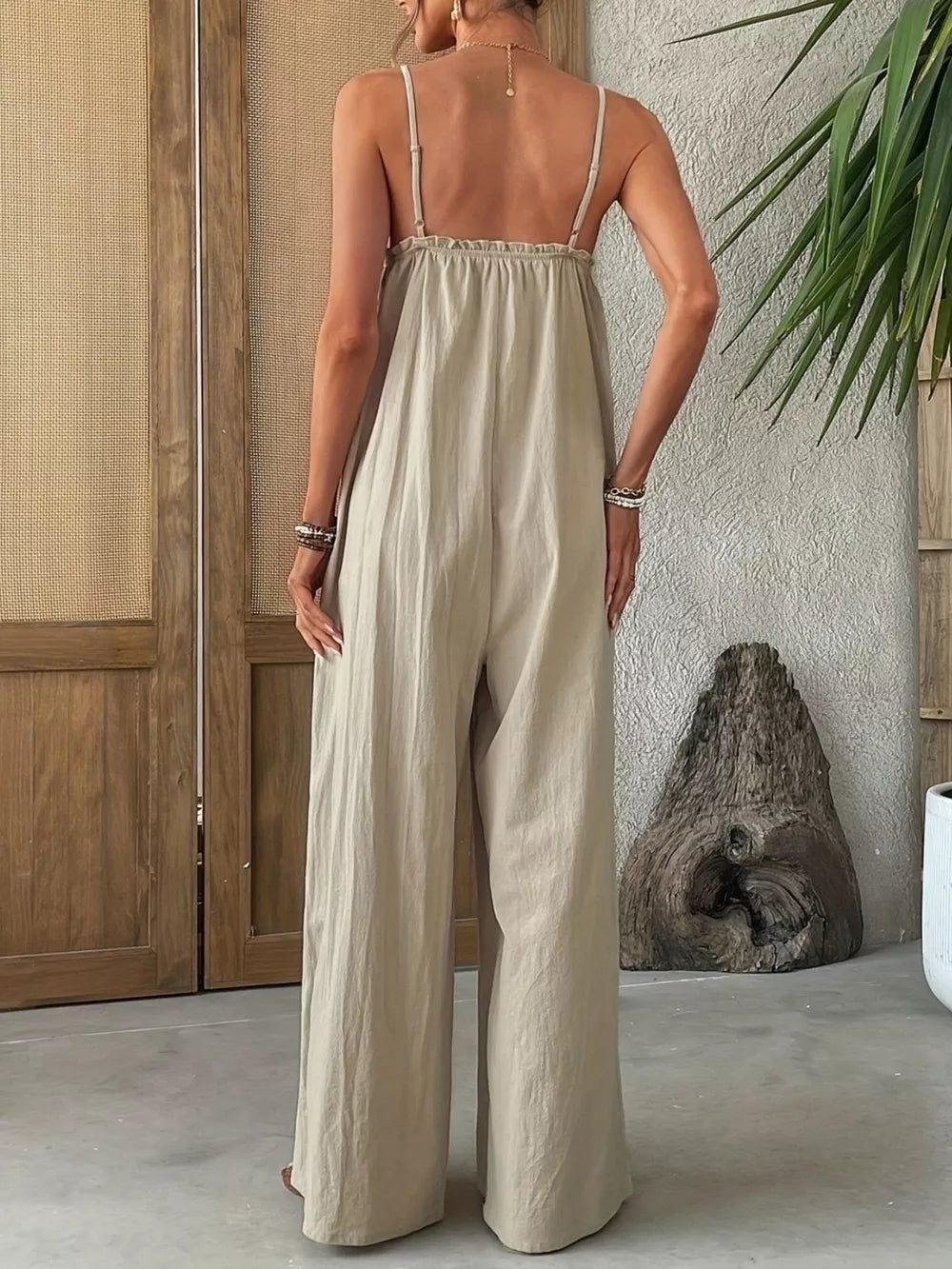 Beige frill-trimmed sleeveless wide-leg jumpsuit with spaghetti straps.