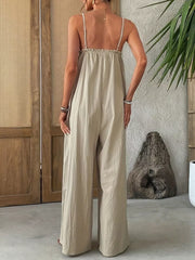 Beige frill-trimmed sleeveless wide-leg jumpsuit with spaghetti straps.