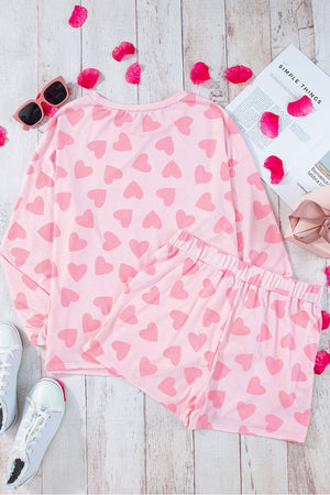 Blush pink heart print pajama set with long sleeves and shorts.