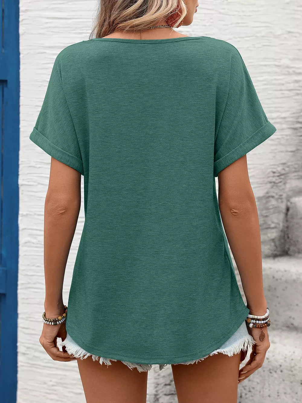 Dark green relaxed fit t-shirt with cuffed short sleeves and lace trim detail.