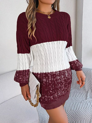 Textured cable knit sweater dress in burgundy and white colorblock with crewneck and long sleeves.