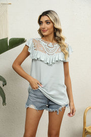 Sage lace yoke ruffle sleeve blouse with round neckline and short sleeves.