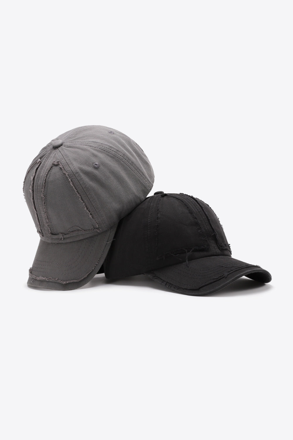 Raw edge denim baseball caps in mid gray and black with distressed details