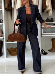 Dark navy high-waisted wide-leg denim jeans with cuffed hems.
