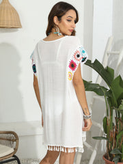 White tunic with colorful crochet sleeves and tassel hem detail
