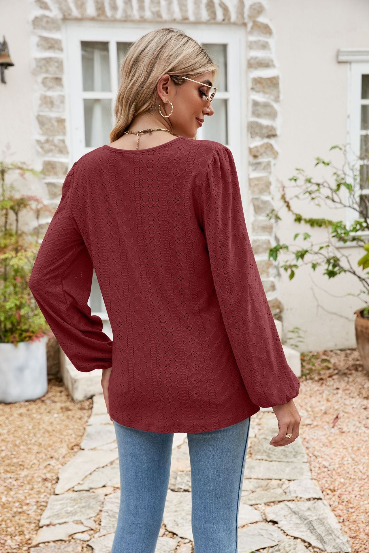 Burgundy eyelet yoke blouse with blouson sleeves and a textured pattern.