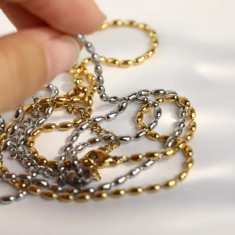 Dual-tone capsule chain necklace in gold and silver with oval bead links.
