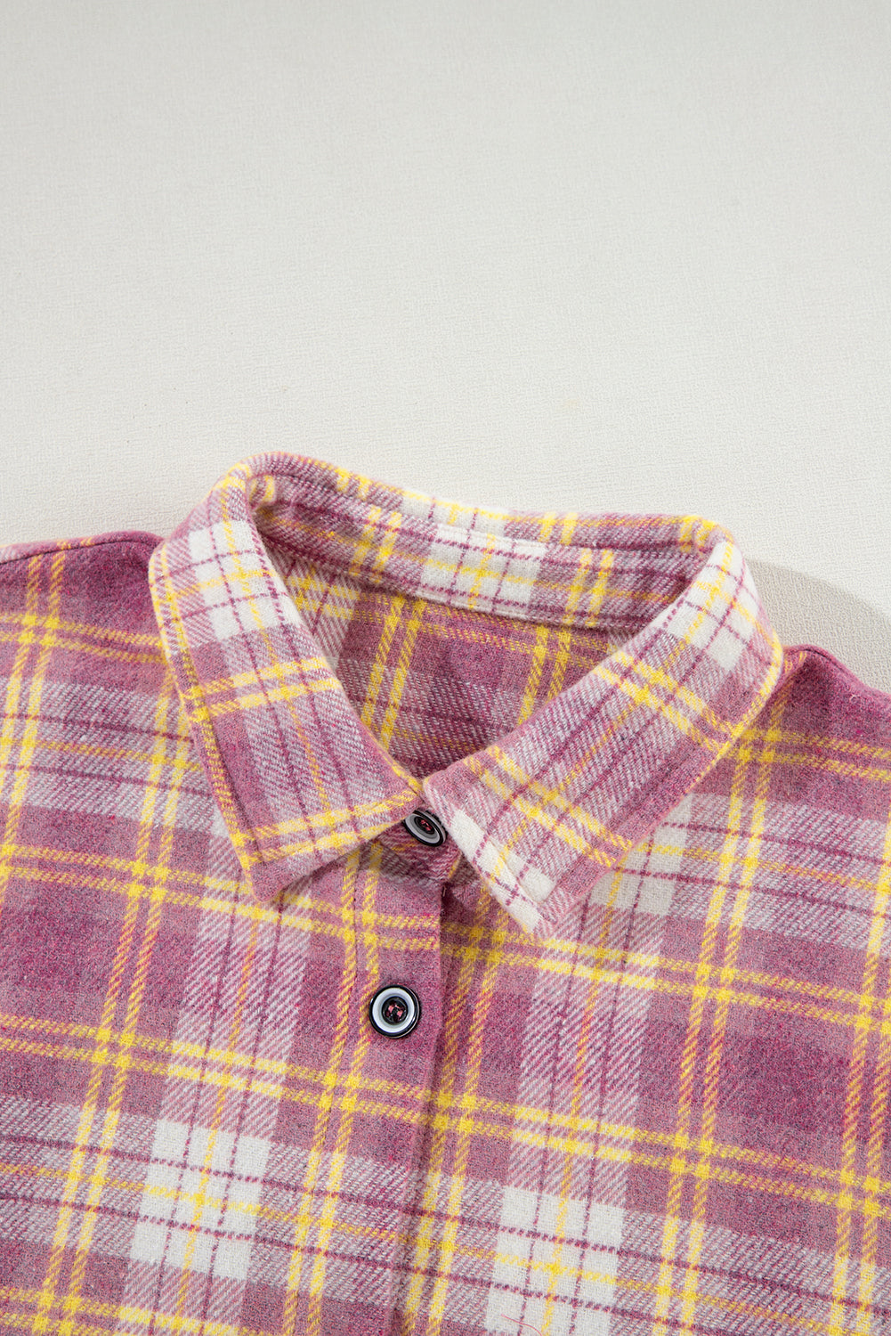 Oversized pink plaid flannel overshirt with button-down front and collar.