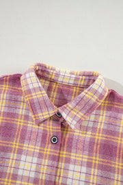 Oversized pink plaid flannel overshirt with button-down front and collar.