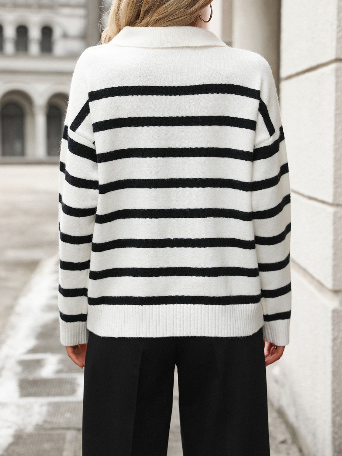 Striped polo-neck knit pullover sweater in white with black horizontal stripes and ribbed cuffs.