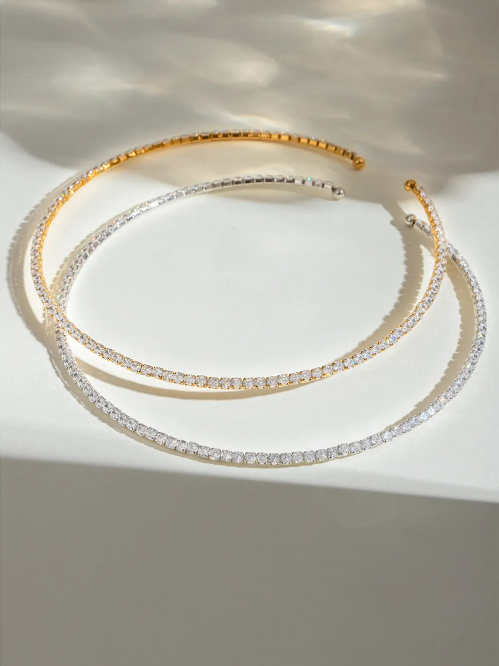 Diamond row collar necklaces in gold and silver, featuring a delicate line of sparkling stones.