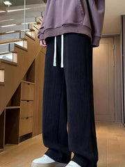 Textured black wide leg sweatpants with white drawstring for men.
