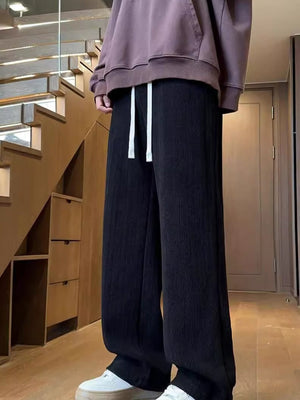 Textured black wide leg sweatpants with white drawstring for men.