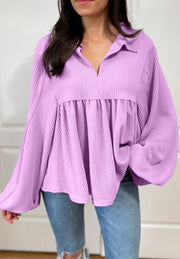 Lilac textured blouse with gathered yoke, collar, and balloon sleeves.