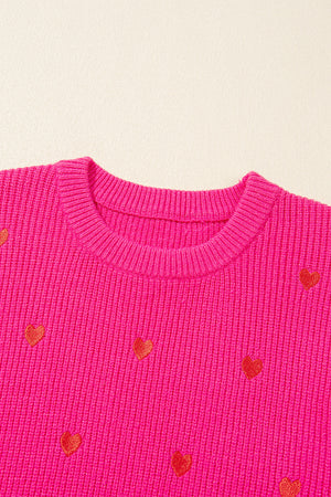 Pink ribbed crewneck sweater with embroidered red hearts, crew neck, long sleeves.