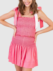 Smocked pink co-ord set with tie straps and ruffled hem skirt.