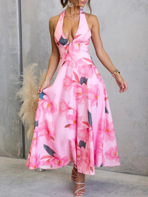 Pink floral halter neck maxi dress with a plunging neckline and a-line skirt.