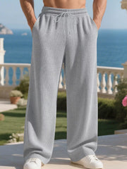Light gray ribbed drawstring sweatpants with relaxed fit and pockets.