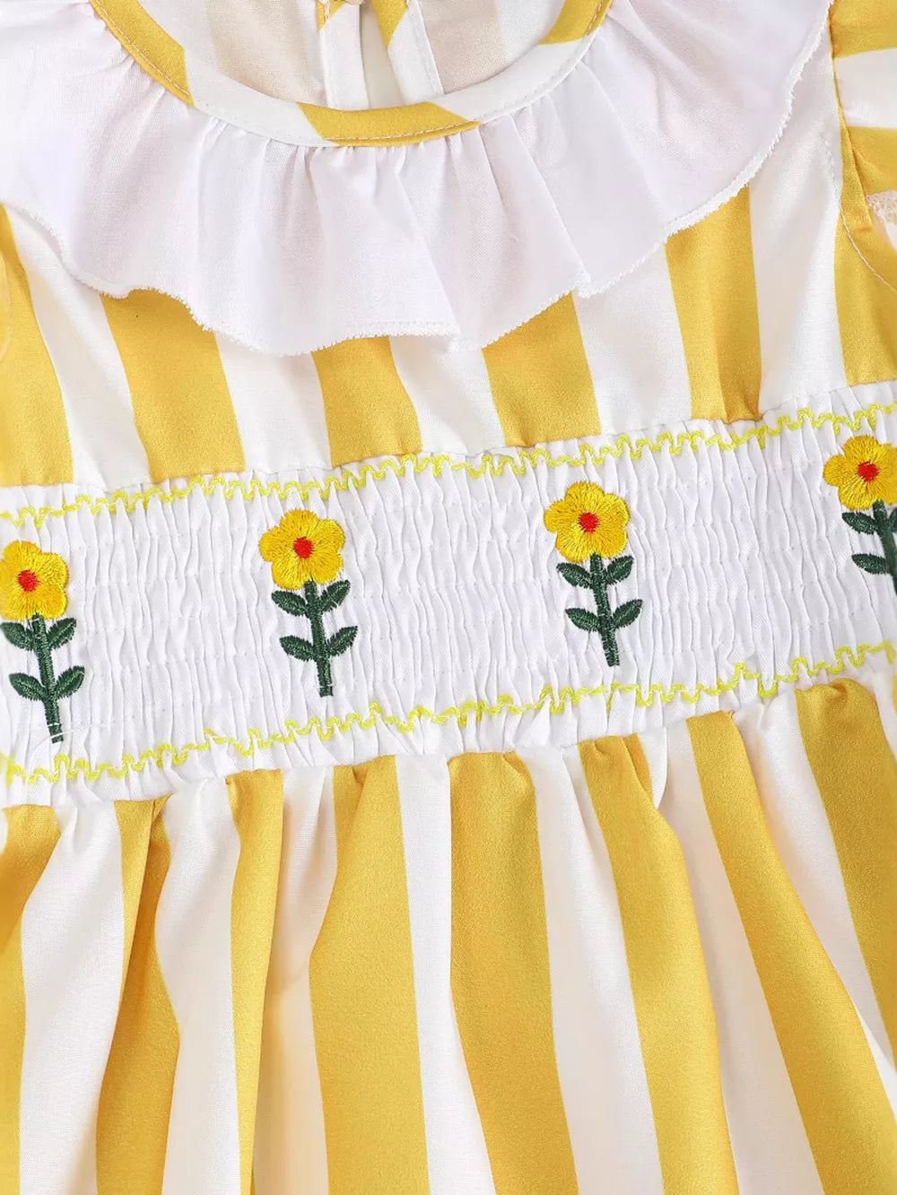 Yellow and white striped baby dress with smocked floral bodice and ruffle collar.