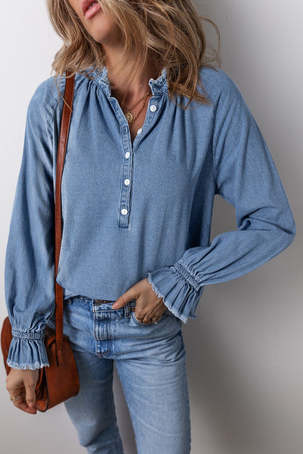 Light blue denim blouse with ruffled collar and cuffs, button front, long sleeves