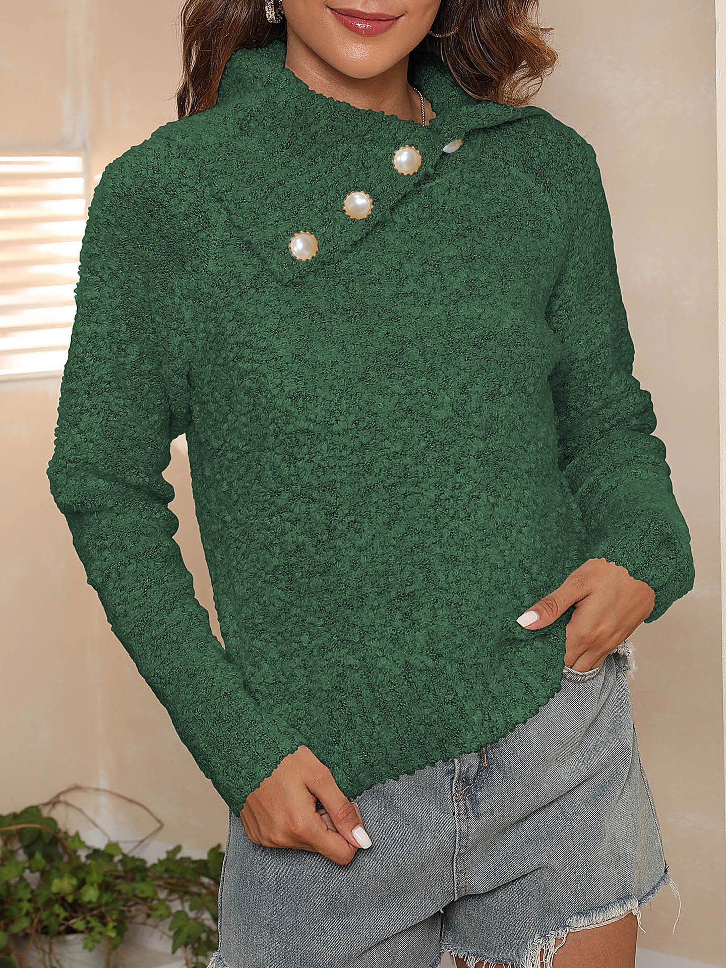 Dark green textured knit sweater with asymmetric pearl button collar and lettuce hem.