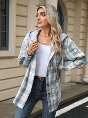 Light blue plaid shacket with contrast hood and button front, worn open over a white tank top.
