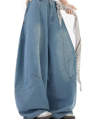 Men's light wash denim wide leg jeans with a casual fit and visible stitching details.