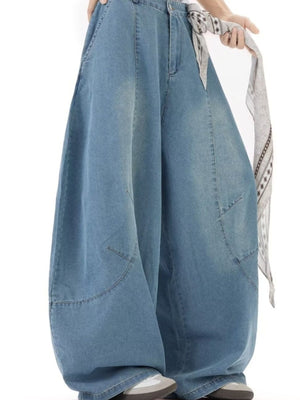 Men's light wash denim wide leg jeans with a casual fit and visible stitching details.