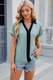 Light Green perforated polo top with black V-neck panel and cuffed short sleeves.