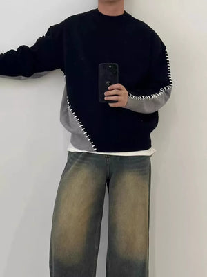 Men's black and gray two-tone mock neck sweater with contrast stitching detail.