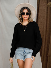 Black diamond-cut raglan knit sweater with crew neck and long sleeves.